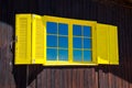 Yellow window on wooden wall Royalty Free Stock Photo