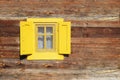 Yellow window on wooden wall Royalty Free Stock Photo