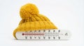Yellow winter hat on a thermometer showing a freezing cold temperature below zero Royalty Free Stock Photo