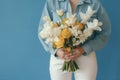 woman floral romantic yellow bouquet tulip hand flower white blue sweater. Generative AI. Royalty Free Stock Photo