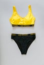 Yellow Women swimsuit, female swimwear Isolated on color gray background. Swimsuit with print words keep distance