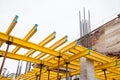 Yellow wooden beams for monolithic building construction