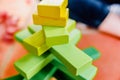 Yellow wooden blocks in balance in a toy tower Royalty Free Stock Photo