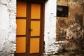 Yellow wooden entrance door with handle in white painted brick wall Royalty Free Stock Photo