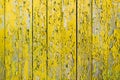 Yellow wooden fence with cracks and old paint Royalty Free Stock Photo