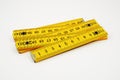 Yellow wooden folding rule on a white Royalty Free Stock Photo