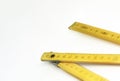 A yellow wooden folding ruler isolated on a white background Royalty Free Stock Photo