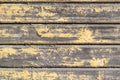 Yellow wooden peeling wall. Old painted boards. Textured tree Background. Royalty Free Stock Photo