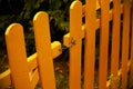 Yellow wooden plank fence with metal hook Royalty Free Stock Photo