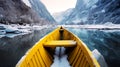 Yellow wooden rowing boat on a calm lake in winter landscape