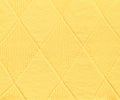 Yellow wool knitted pattern with diamond shapes, texture background Royalty Free Stock Photo