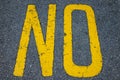 The yellow word NO painted on street