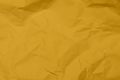 Closeup yellow crumpled paper texture background. Yellow wrinkled paper texture background. Yellow crease fabric texture