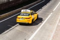 Yellow yandex taxi car, rear side view. Aerial photography of Kia Optima riding in Moscow streets