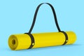 Yellow yoga mat or lightweight foam camping bed roll pad isolated on blue .