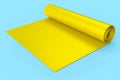 Yellow yoga mat or lightweight foam camping bed roll pad isolated on blue .
