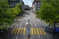A yellow zebra pedestrian crosswalk in Zurich city Switzerland. Low traffic, high viewpoint, sunny summer day, hystoric downtown
