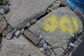 Yellow zero zero one symbol on a dam rock