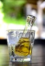 yellow or  zolta rakia, grape brandy in small glass bottle on glass with ice. famous alcoholic drink from Macedonia Royalty Free Stock Photo