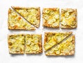 Yellow zucchini puff pastry mini tarts on a light background, top view. Tasty snack, tapas