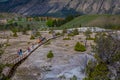YELLOWSTONE, MONTANA, USA JUNE 02, 2018: Above view of group of people walking in a boardwalk in Mammoth hot springs