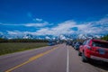 YELLOWSTONE, MONTANA, USA MAY 24, 2018: Outdoor view of cars parked at one side of the road from Yellowstone National