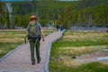 YELLOWSTONE, MONTANA, USA MAY 24, 2018: Outdoor view of female park ranger wearing a green uniform with a backpack Royalty Free Stock Photo
