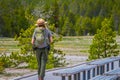 YELLOWSTONE, MONTANA, USA MAY 24, 2018: Outdoor view of female park ranger wearing a green uniform with a backpack Royalty Free Stock Photo