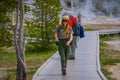 YELLOWSTONE, MONTANA, USA MAY 24, 2018: Outdoor view of unidentified tourists talking with a female park ranger over the Royalty Free Stock Photo