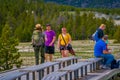 YELLOWSTONE, MONTANA, USA MAY 24, 2018: Outdoor view of unidentified tourists talking with a female park ranger over the Royalty Free Stock Photo