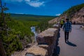 YELLOWSTONE, MONTANA, USA MAY 24, 2018: Unidentified people walking in the border of a clif and enjoying the view of Royalty Free Stock Photo