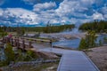 YELLOWSTONE, MONTANA, USA MAY 24, 2018: Unidentified tourists walking in the wooden bridge over firehole river in the Royalty Free Stock Photo