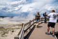 Tourists illegaly bring their pet dog on the boardwalks through the thermal geyser area