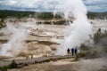 Yellowstone National Park, Wyoming - June 28, 2020: Tourist hikers take photos of the geysers and thermal features in Norris
