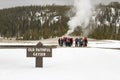 Tourists at Old Faithful geyser, Yellowstone National Park, Wyoming Royalty Free Stock Photo