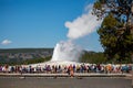 Yellowstone, Wyoming, USA, August 19, 2019, tourists gather around to watch Old Faithful Giser erupt