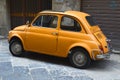 Yellowy orange fiat 500, Sicily Italy Royalty Free Stock Photo