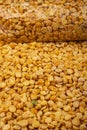 YelloYellow split peas in a plastic bag and cereal in bulk on a background of burlap with a rough texture. Traditional cereals for Royalty Free Stock Photo