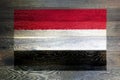 Yemen flag on rustic old wood surface background