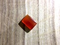 Yemeni red aqeeq agate stone on wood