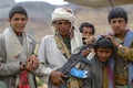 Yemeni teenagers in traditional dresses pose with Kalashnikov machine gun, Hadramaut valley, Yemen.