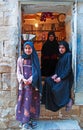 A yemeni woman and two yemeni girls in Thula, village, cistern, wooden door, Yemen