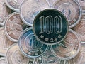 100 yen lies on a pile of Japanese 1 yen coins. Close up. View from above. Catchy money illustration. News about the economy and Royalty Free Stock Photo