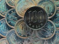 100 yen lies on a pyramid of Japanese 1 yen coins. View from above. Inverted colors. Dark catchy illustration. Money seems to be Royalty Free Stock Photo