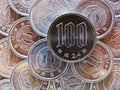 100 yen lies on a pyramid of Japanese 1 yen coins. Close up. View from above. Catchy bright money illustration. News about the Royalty Free Stock Photo