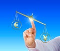 Yen Sign Outweighing The Euro On A Golden Scale Royalty Free Stock Photo