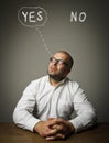 Yep concept. Man in white is full of doubts Royalty Free Stock Photo