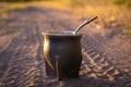 Yerba mate gourd cup on dusty road on sunlight