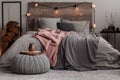 Yerba matte on wooden plate on grey woolen pouf in stylish bedroom