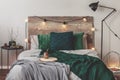 Yerba matte on wooden plate on bed with grey bedding and emerald grey blanket